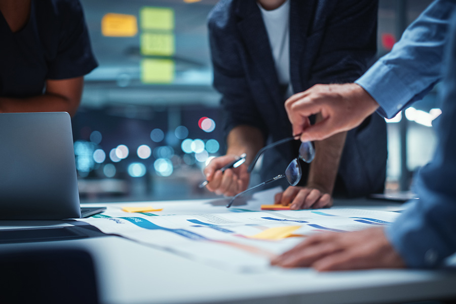 Closeup of individuals at a table looking over plans