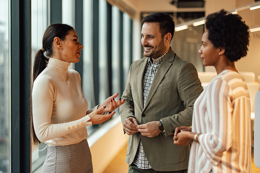 Group of professionals having a conversation in a corporate environment